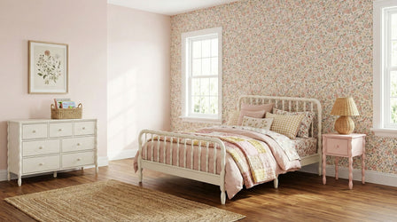 Bedroom with floral wallpaper, white wooden Jenny Lind style bed with matching dresser and nightstand and a textured area rug in the center of the room.