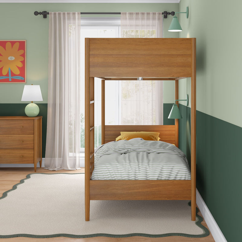 Wooden bunk bed in a modern mint-green kids' bedroom with gray-and-white striped bedding, yellow accent pillow, matching wooden dresser and lamp, sheer curtains and scalloped rug