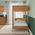 Wooden bunk bed in a modern mint-green kids' bedroom with gray-and-white striped bedding, yellow accent pillow, matching wooden dresser and lamp, sheer curtains and scalloped rug
