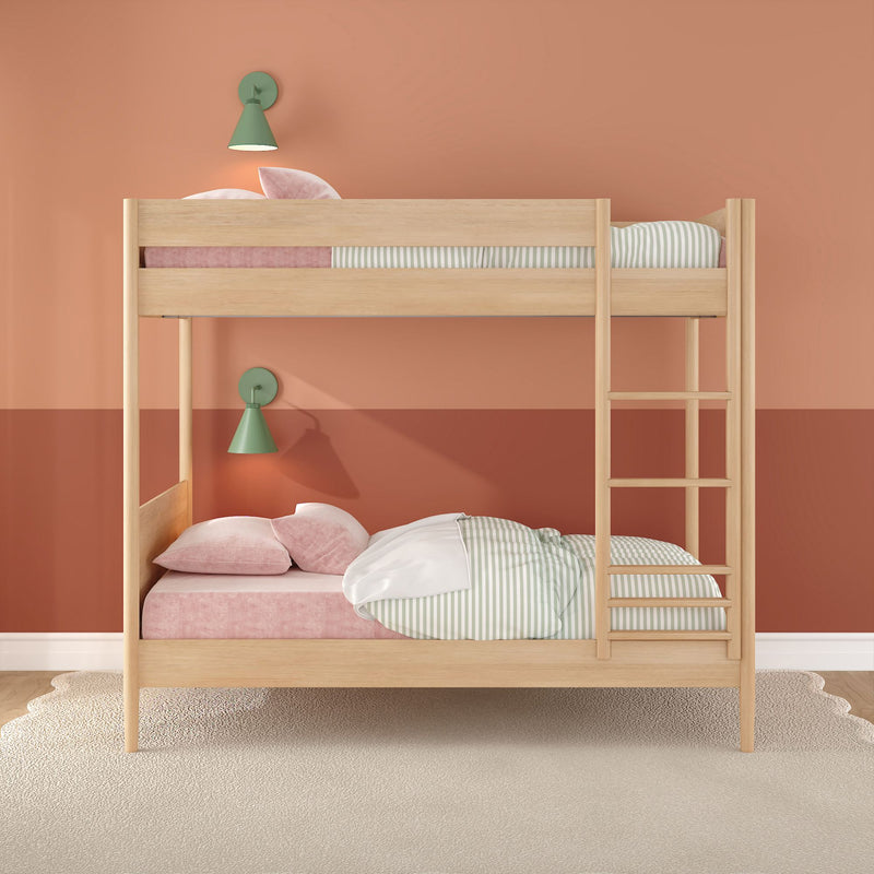Light-wood bunk bed in kids' bedroom with coral two-tone wall, pink velvet bedding, green wall lamps and striped sheets
