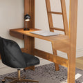 Modern wooden loft bed with built-in desk, closed silver laptop, black task lamp and gray swivel office chair in a minimalist small home office setup