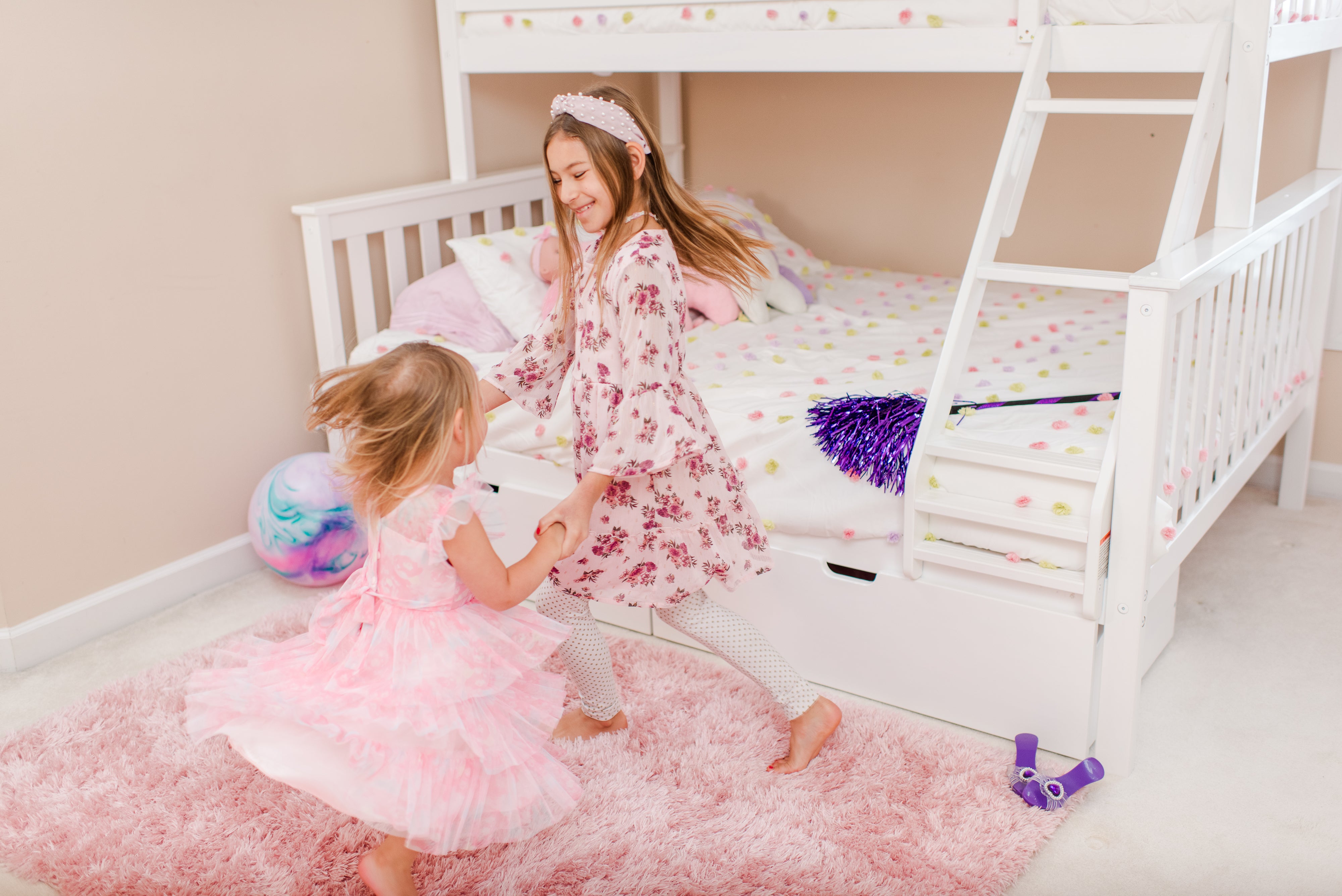 Children playing on a bunk bed in a bright, well-lit room.