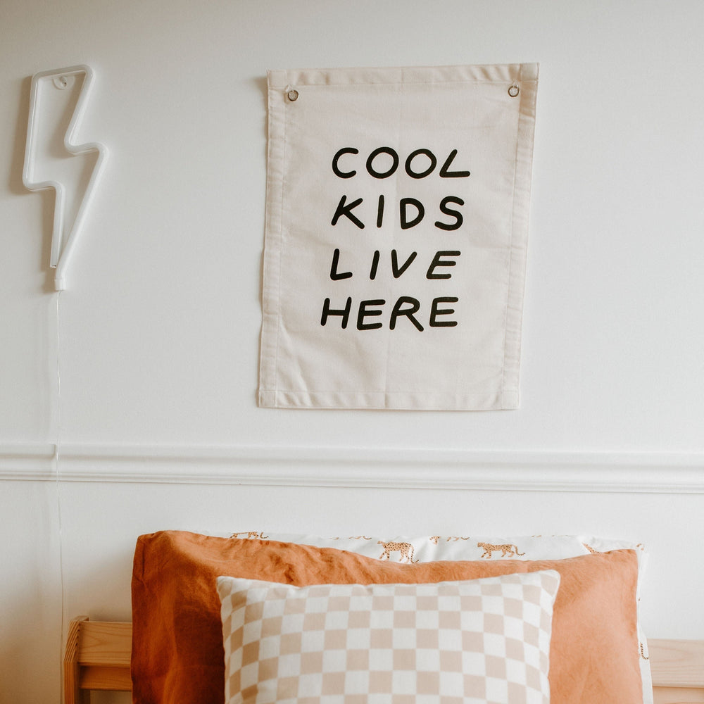 Cool kids room decor with wall poster and stylish bedding.