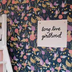 Floral wall art with "Long Live Girlhood" text on colorful botanical background.