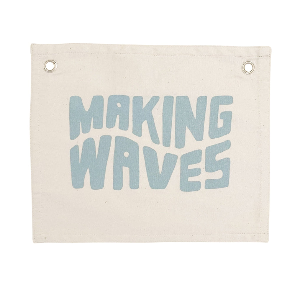 Decorative canvas wall hanging with the words "Making Waves" in blue letters.