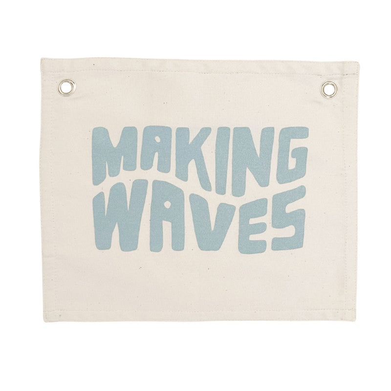 Decorative canvas wall hanging with the words "Making Waves" in blue letters.