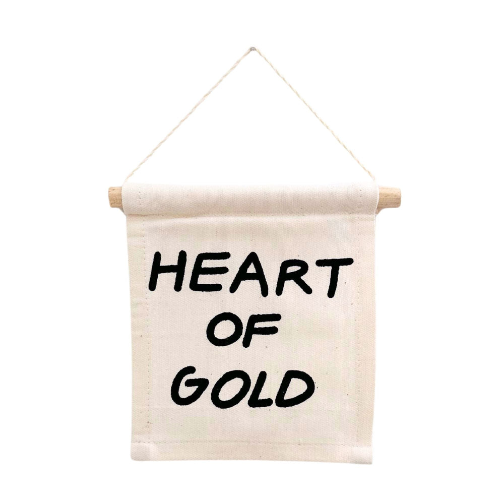 Decorative wall hanging with 'Heart of Gold' text, perfect for home decor enthusiasts seeking inspirational quotes.