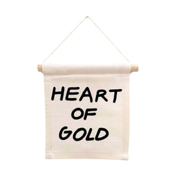 Decorative wall hanging with 'Heart of Gold' text, perfect for home decor enthusiasts seeking inspirational quotes.