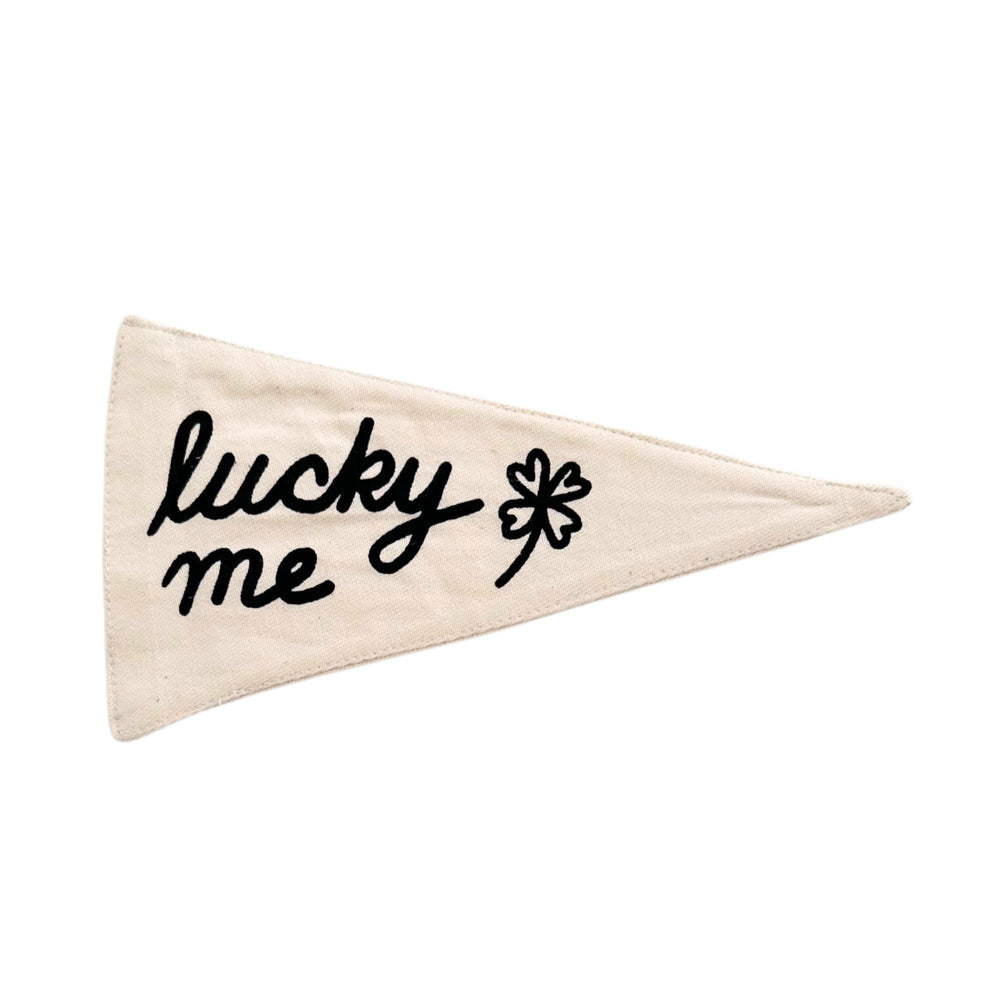Cream triangular pennant with "lucky me" and a four-leaf clover design for positive vibes.