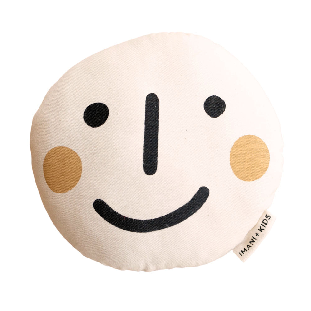 Smiley face cushion designed for kids by Imani+Kids, featuring a minimalist black and beige pattern.