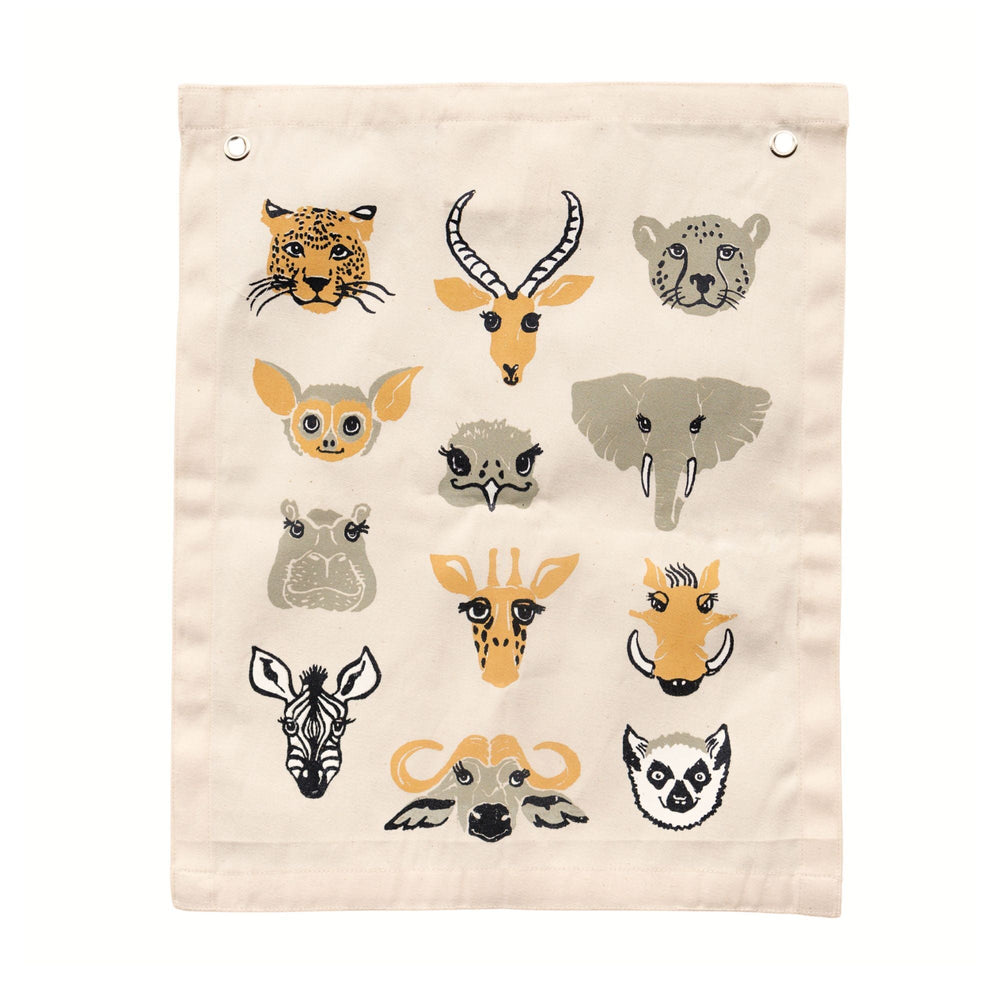 Illustrated canvas wall hanging with animal faces including leopard, elephant, zebra, and giraffe on beige background.