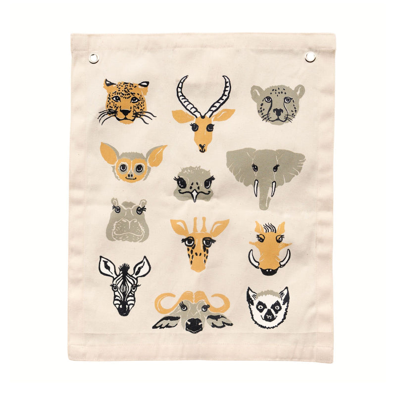Illustrated canvas wall hanging with animal faces including leopard, elephant, zebra, and giraffe on beige background.