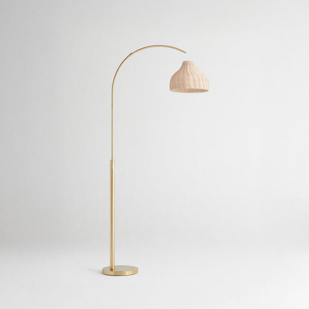 Elegant gold floor lamp with an arched design and a woven beige shade, perfect for modern interior lighting decor.