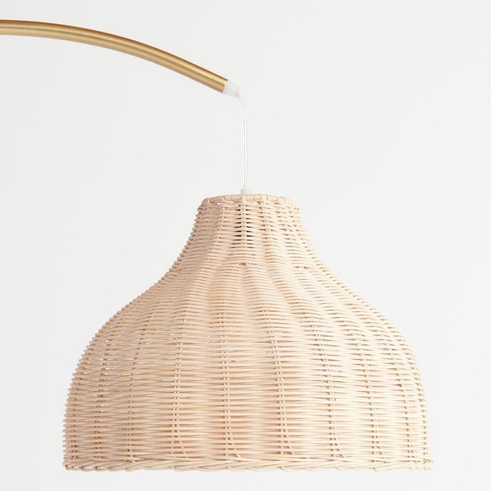Wicker pendant lamp with gold arm in minimalist design for modern interiors.