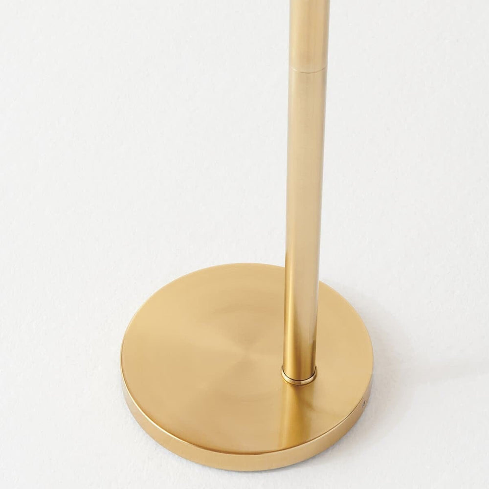 Modern gold metal lamp base on white background.