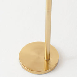 Modern gold metal lamp base on white background.