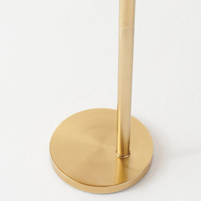 Modern gold metal lamp base on white background.