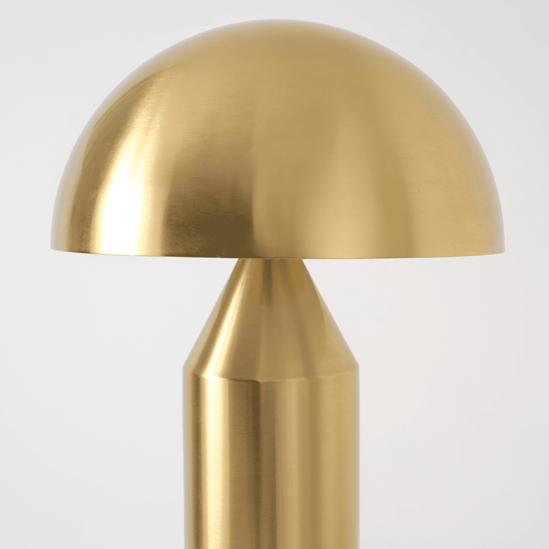 Golden dome-shaped metal table lamp with a sleek modern design.