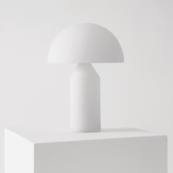 Minimalist white table lamp on a white pedestal, showcasing contemporary interior design.
