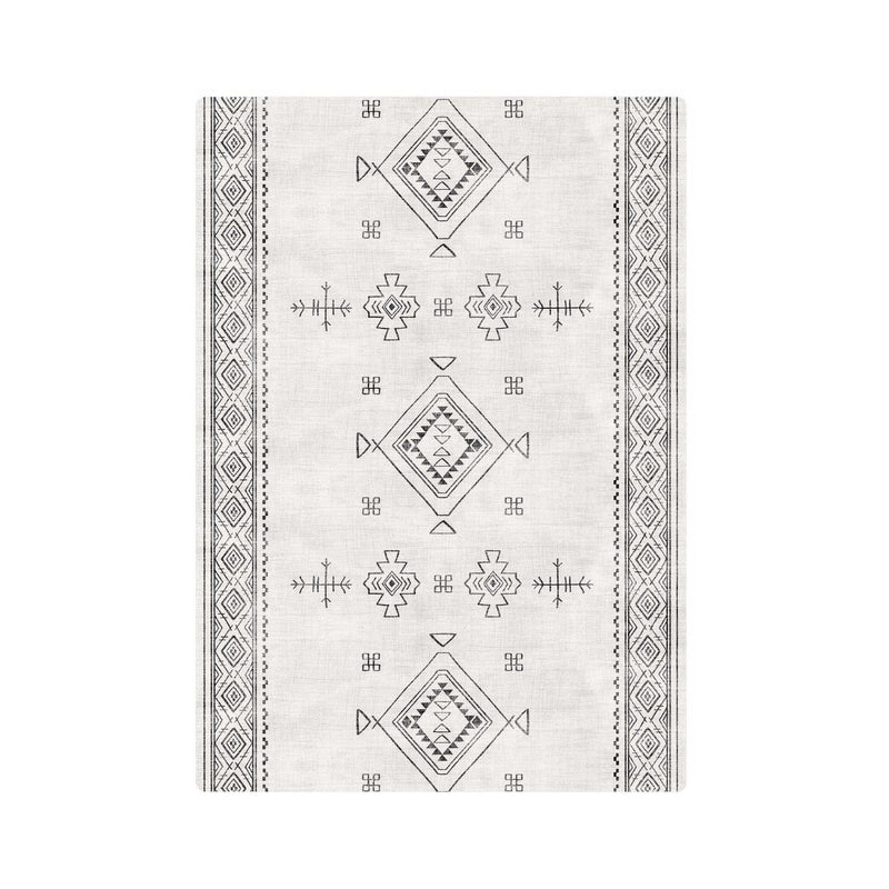 Geometric patterned area rug in black and white design with intricate border.