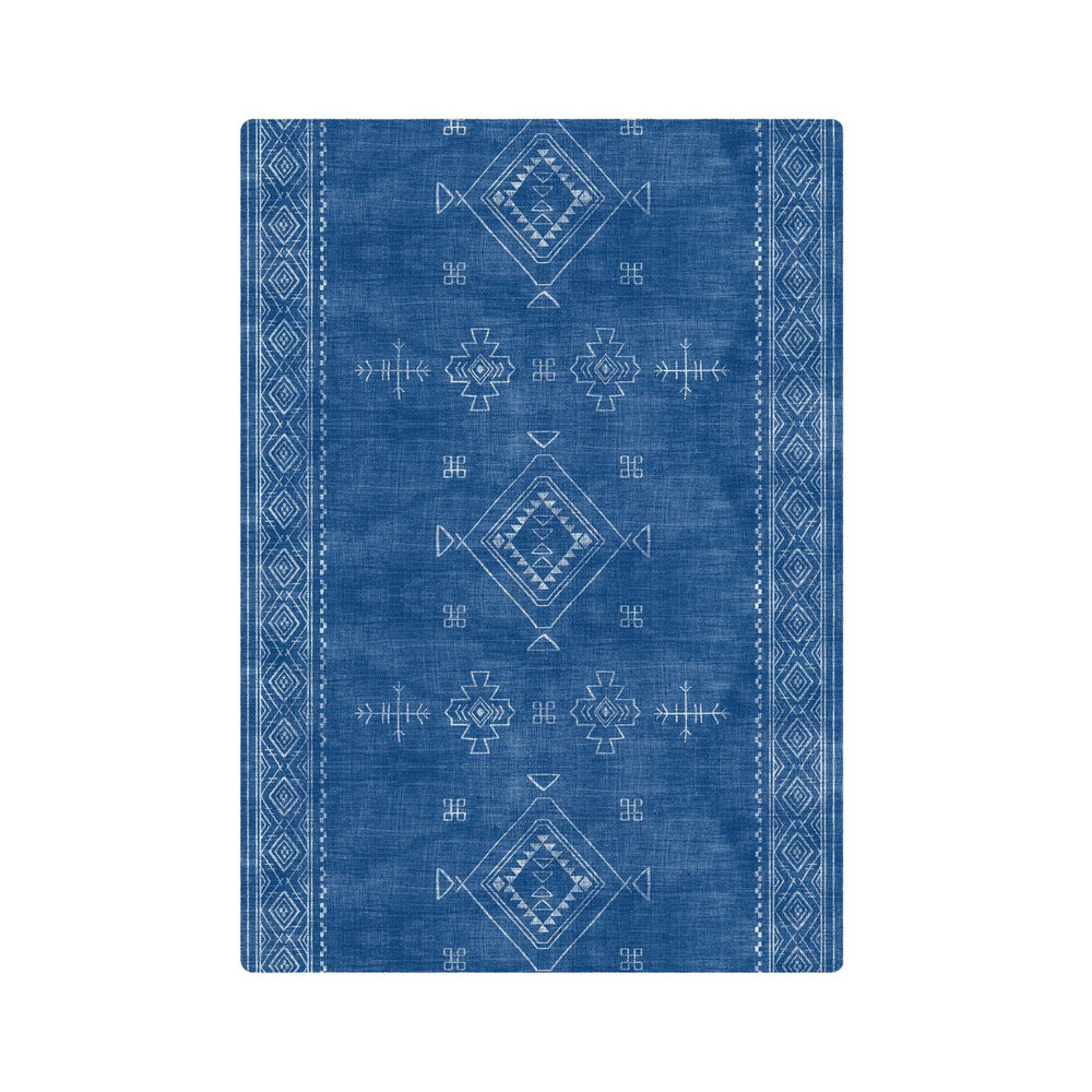 Blue tribal geometric pattern rug with intricate white designs, ideal for modern and bohemian home decor.