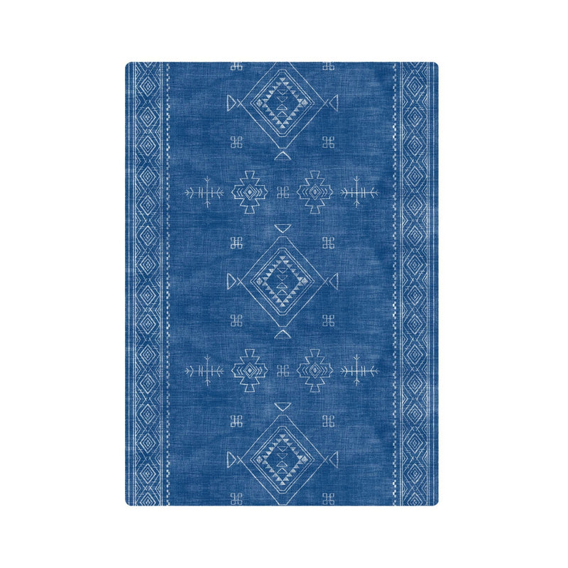 Blue tribal geometric pattern rug with intricate white designs, ideal for modern and bohemian home decor.