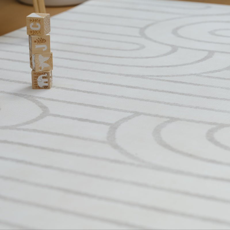 Wooden blocks with animal engravings stacked on textured white surface.