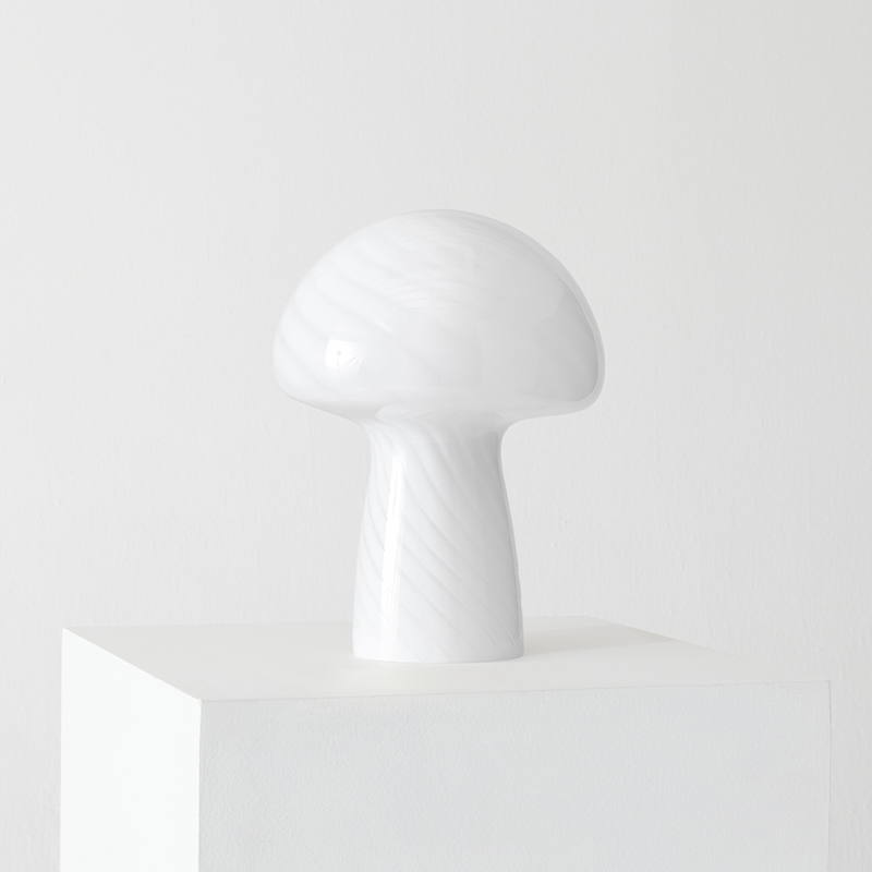 White ceramic mushroom lamp on a minimalist white pedestal against a plain background.