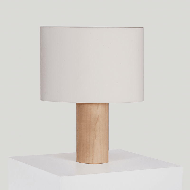 Modern wooden table lamp with white shade on display.