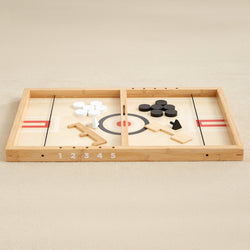 Wooden tabletop curling game with black and white discs on a numbered board.