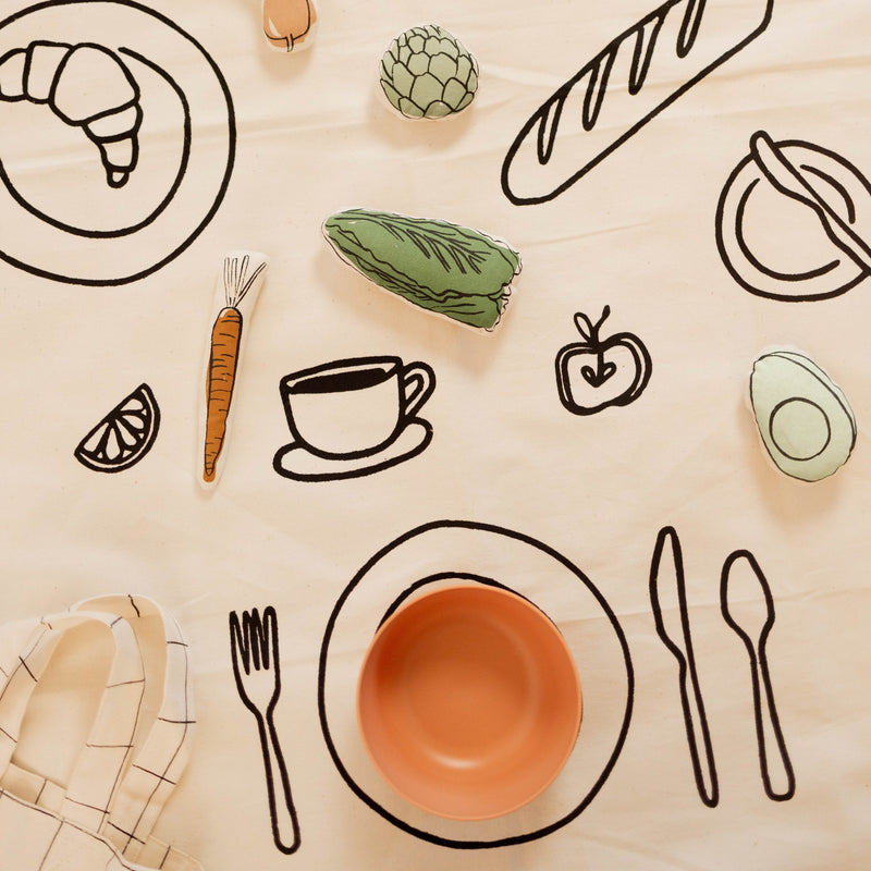 Illustrated food-themed tablecloth with bread, croissant, and vegetables, perfect for kitchen decor.