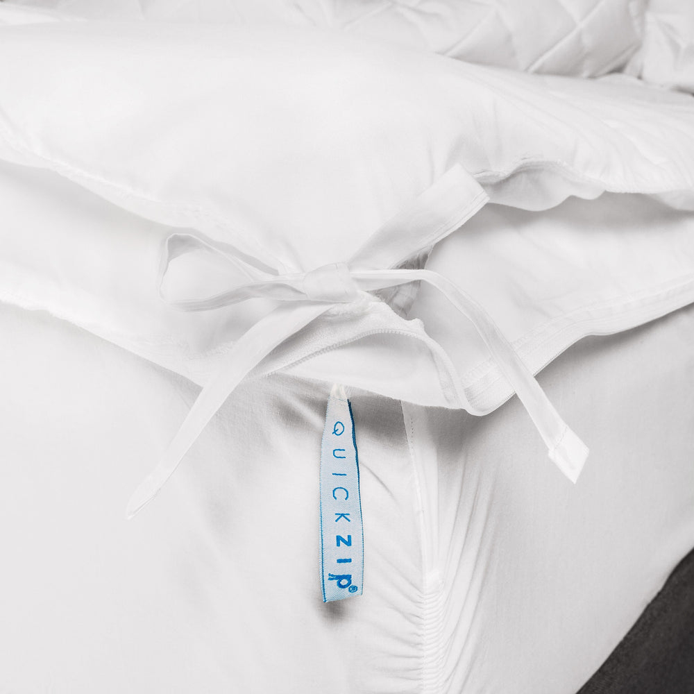 Innovative QuickZip white bedsheet corner with secure fastenings for easy bedding solutions.