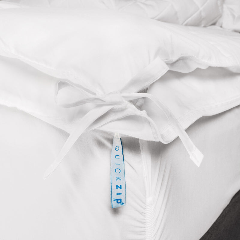 Innovative QuickZip white bedsheet corner with secure fastenings for easy bedding solutions.