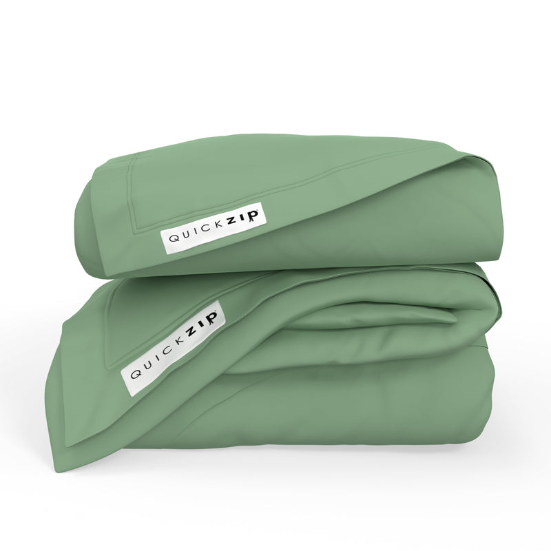 Soft sage green cotton duvet cover by QuickZip, folded neatly, showcasing premium bedding quality.