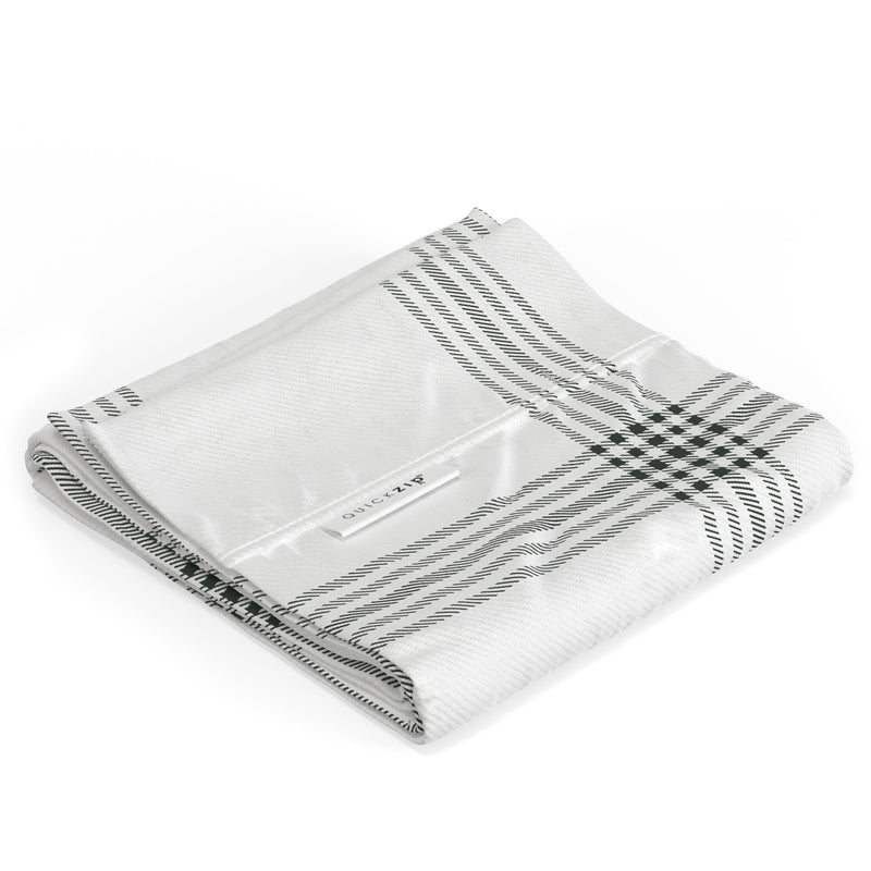 Folded black and white checkered fabric showcasing QuickZip label, ideal for bedding and home textiles.