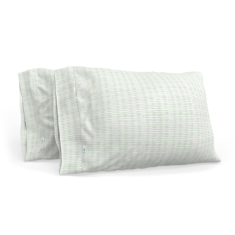 Set of two green striped pillows on a white background, perfect for bedroom decor and comfort.