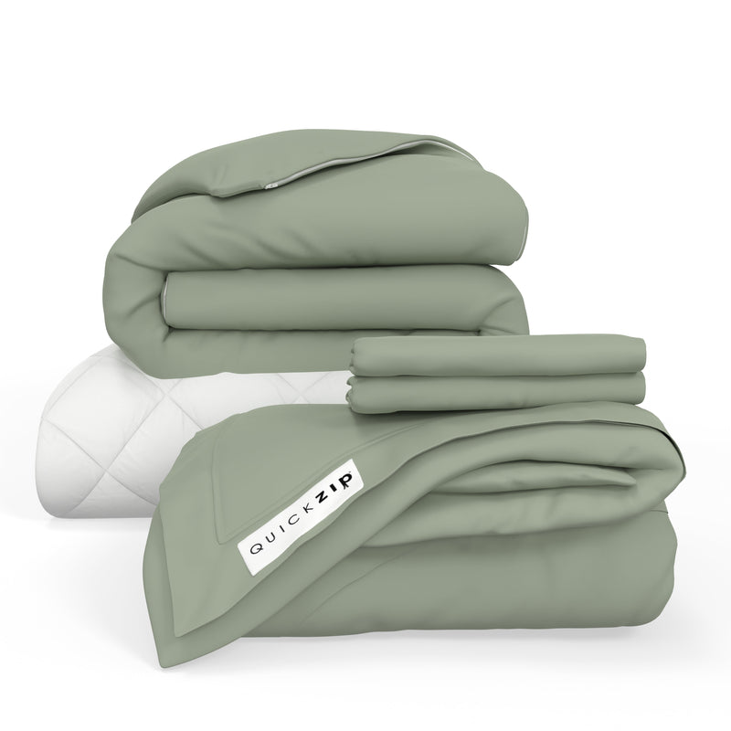 Eco-friendly sage green bedding set with QuickZip label, including comforter, sheets, and pillowcase on white background.