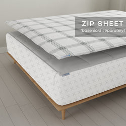 Modern zip sheet bedding on wooden bed frame, highlighting removable top layer for easy cleaning.