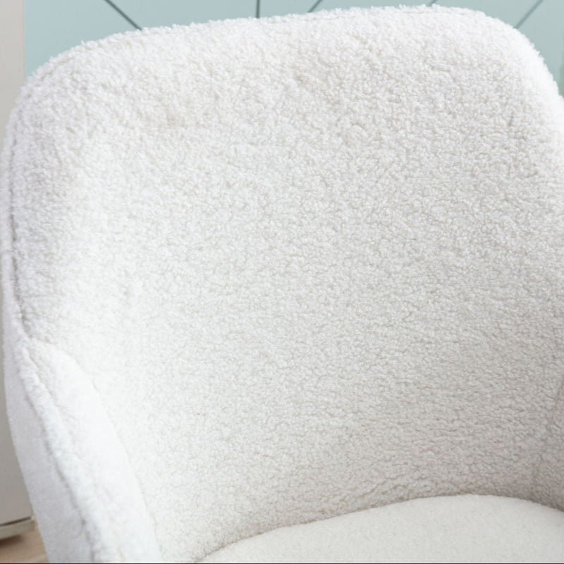 Cozy white boucle chair in modern home office setting.