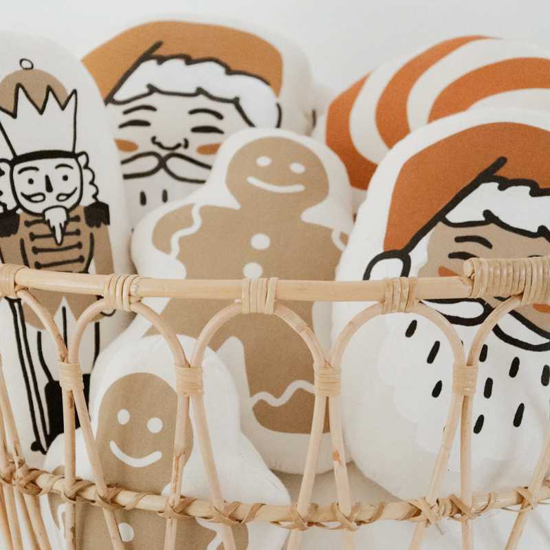Basket of festive holiday-themed cookies, including gingerbread and Santa designs.