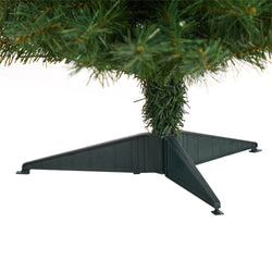 Close-up of green artificial Christmas tree base with plastic tripod stand and PVC branch tips on white background