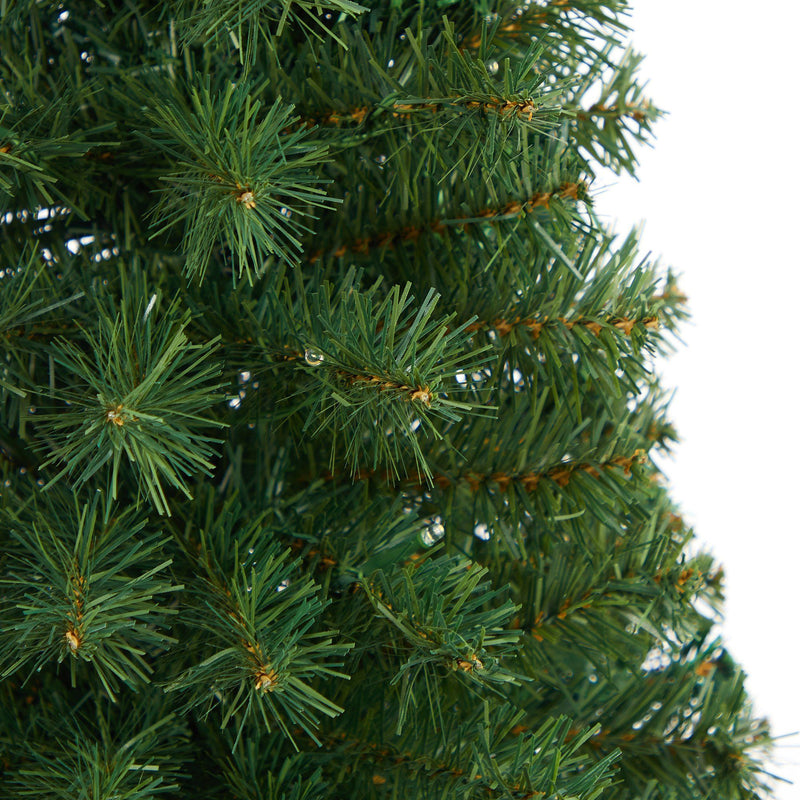 Close-up of realistic artificial Christmas tree branches with dense green pine needles and brown stems, holiday evergreen foliage