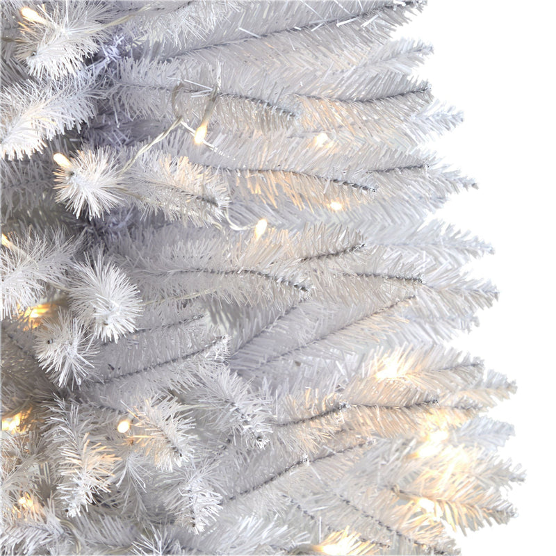 Close-up of white artificial Christmas tree pre-lit with warm white LED lights, dense PVC branches ideal for modern holiday decor