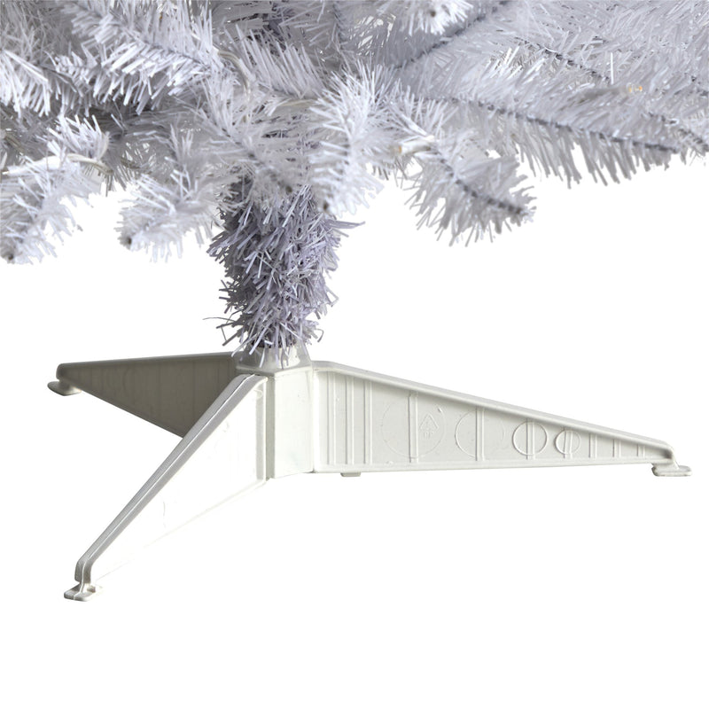 White plastic tripod Christmas tree stand supporting white artificial Christmas tree branches, sturdy collapsible base for indoor holiday decor