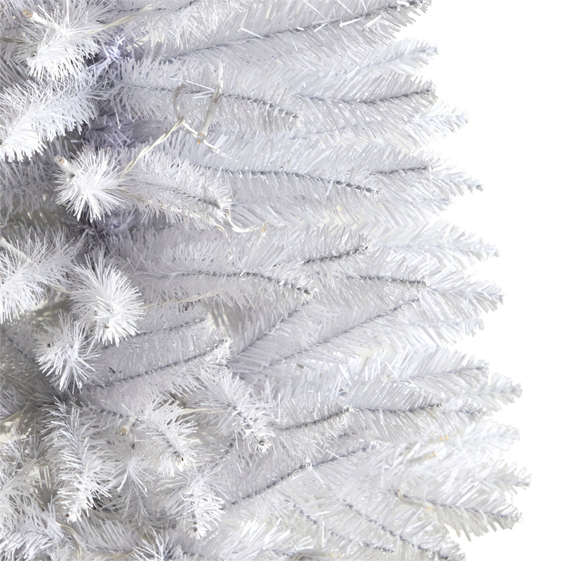 Close-up of white artificial pre-lit Christmas tree branches with dense PVC needles, modern holiday decor and winter home decoration
