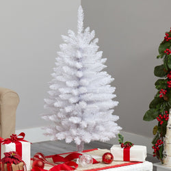 Small white artificial Christmas tree next to red ornaments, wrapped gifts and greenery in modern living room holiday decor