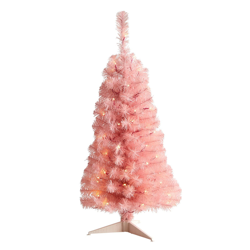 Pink artificial pre-lit Christmas tree with warm white lights and tinsel branches on a metal stand, holiday home decor on white background