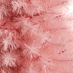 Close-up of pink artificial Christmas tree branches with fluffy PVC bristles and wired stems for pastel holiday decor