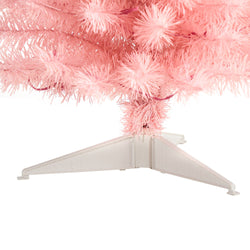 Close-up of pink artificial Christmas tree tinsel branches and white plastic tripod stand, festive holiday decor