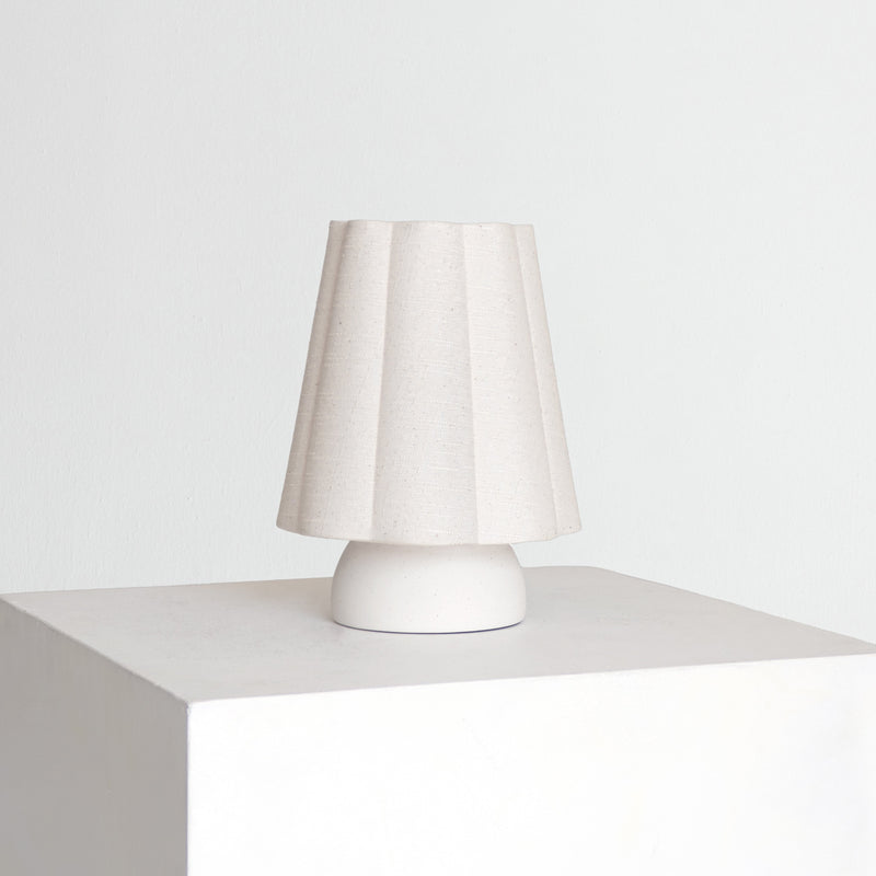 Minimalist white ceramic table lamp with pleated fabric shade — modern bedside lamp for Scandinavian bedroom decor